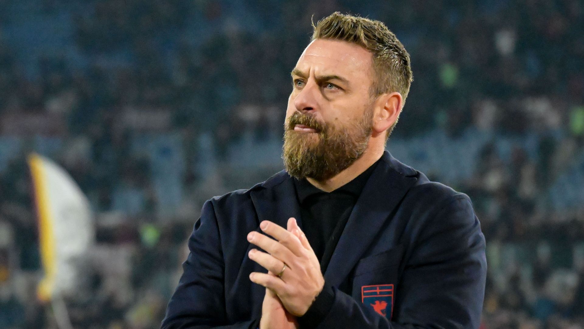 De Rossi sorry for 'stern face'